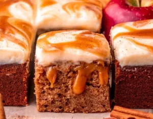 Apple Cider Cake 2 Delicious homemade Apple Cider Cake served on a wooden table with apple slices