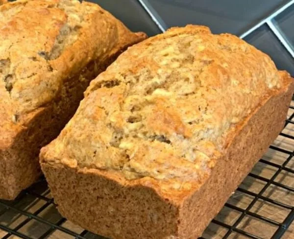 Easy Apple Bread Recipe 2 Sliced easy apple bread with nuts on a wooden board