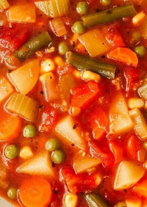 Bowl of hearty vegetable soup filled with vibrant, fresh vegetables