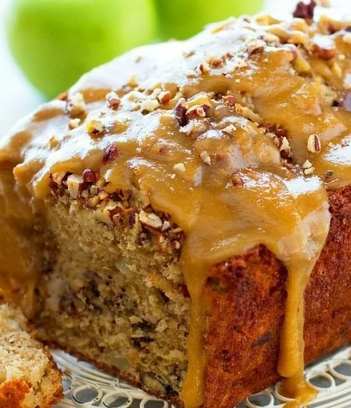 Delicious slice of homemade Praline Apple Bread topped with nuts and caramel