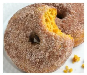 Pumpkin Cinnamon Sugar Donuts 2 Freshly baked Pumpkin Cinnamon Sugar Donuts on a rustic wooden table