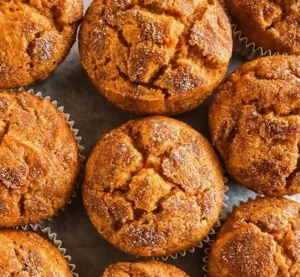 Pumpkin Muffins 2 Freshly baked pumpkin muffins with spices and frosting on a wooden table