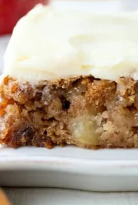 Apple Cake with Cream Cheese Frosting 6 Slice of apple cake topped with creamy frosting on a plate