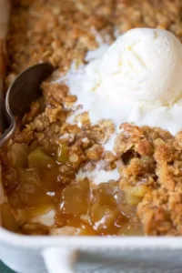 Delicious apple crisp dessert served in a bowl with oats and apples