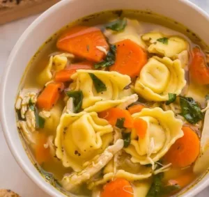Chicken Tortellini Soup 4 Bowl of Chicken Tortellini Soup with fresh herbs and vegetables