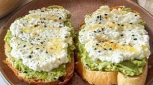Cottage Cheese Avocado Toast Extra Creamy 3 Extra creamy cottage cheese avocado toast topped with fresh herbs and spices.