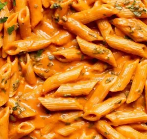 Creamy Tomato Pasta 4 Delicious creamy tomato pasta garnished with basil and parmesan cheese