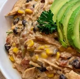 Crock Pot Fiesta Chicken dish served with colorful toppings and sides.