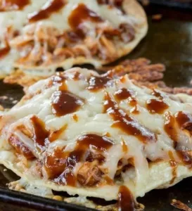 Plate of easy BBQ chicken tostadas topped with fresh ingredients