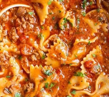 Delicious bowl of easy lasagna soup topped with cheese and fresh herbs