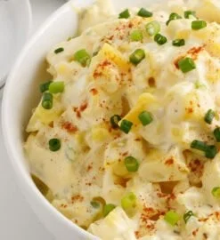 Bowl of creamy potato salad with herbs and spices