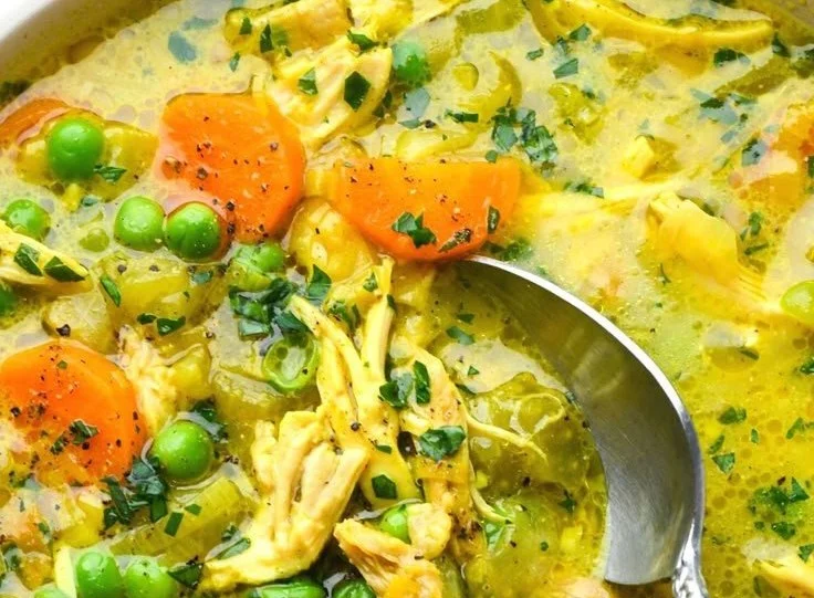 Healing Turmeric Chicken Soup 2 Bowl of healing turmeric chicken soup garnished with herbs