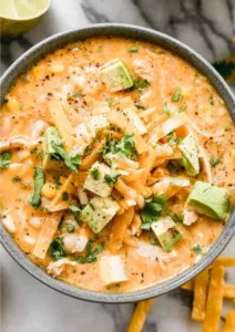 Healthy High Protein White Chicken Chili 6 Bowl of healthy high protein white chicken chili topped with fresh herbs.