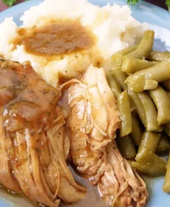 Mississippi Chicken 4 Delicious plate of Mississippi Chicken served with sides, showcasing Southern cuisine.