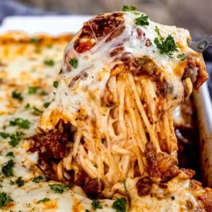 Delicious spaghetti bake served in a ceramic dish with melted cheese on top