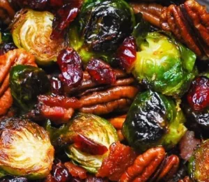 Thanksgiving Side Dish - Brussels sprouts with Bacon, Pecans, Cranberries, and Balsamic Glaze. 6 Brussels sprouts with bacon, pecans, cranberries, and balsamic glaze on a plate.