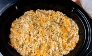 The Slow-Cooker Trick That Keeps Chicken & Rice Creamy—Not Mushy 6 Creamy chicken and rice dish prepared in a slow cooker for a perfect meal.
