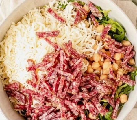 Close-up of La Scala Chopped Salad with lettuce, salami, and tangy dressing