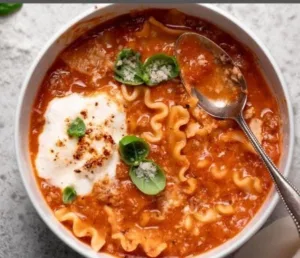 Comfort Food Lasagna Soup with Bubbly Ricotta Cheese 6 Delicious lasagna soup topped with creamy ricotta cheese in a bowl.