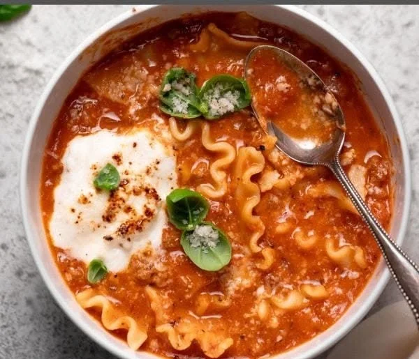 Delicious lasagna soup topped with creamy ricotta cheese in a bowl.