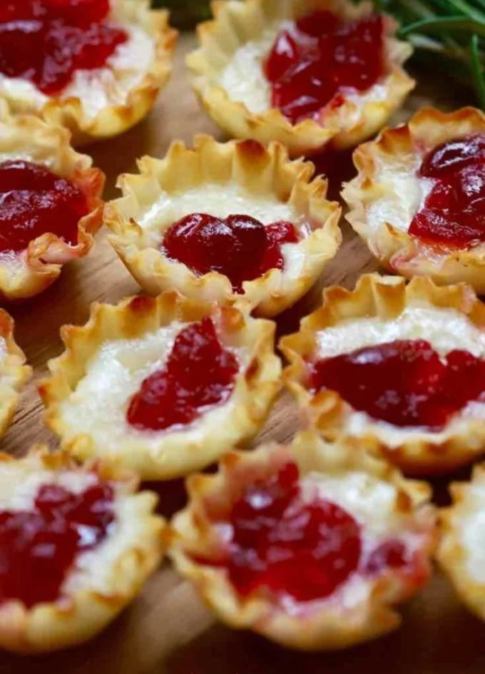Cranberry Brie Bites served on a festive holiday platter