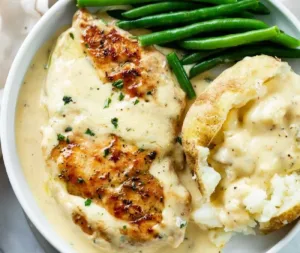 Easy Creamy Ranch Chicken Recipe 4 Easy creamy ranch chicken dish ready to serve with fresh herbs and spices.