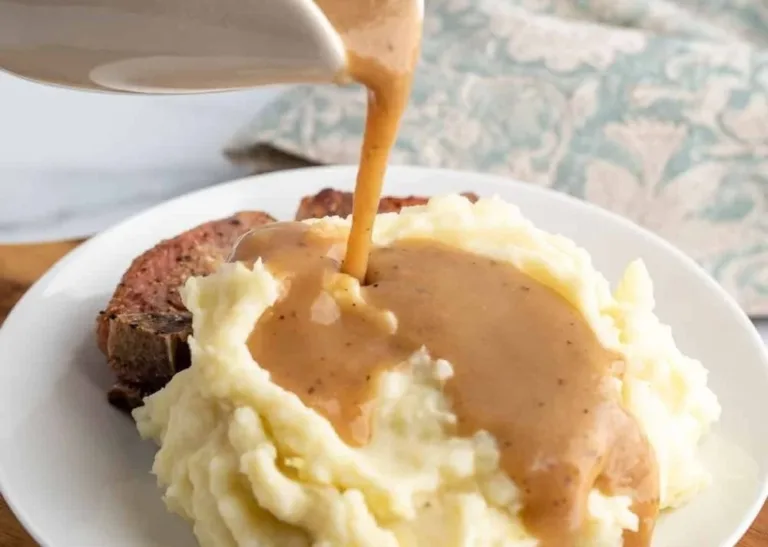 Delicious homemade brown gravy poured over mashed potatoes