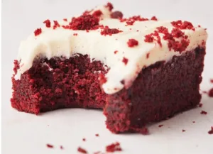 Delicious red velvet brownies with cream cheese frosting on a plate