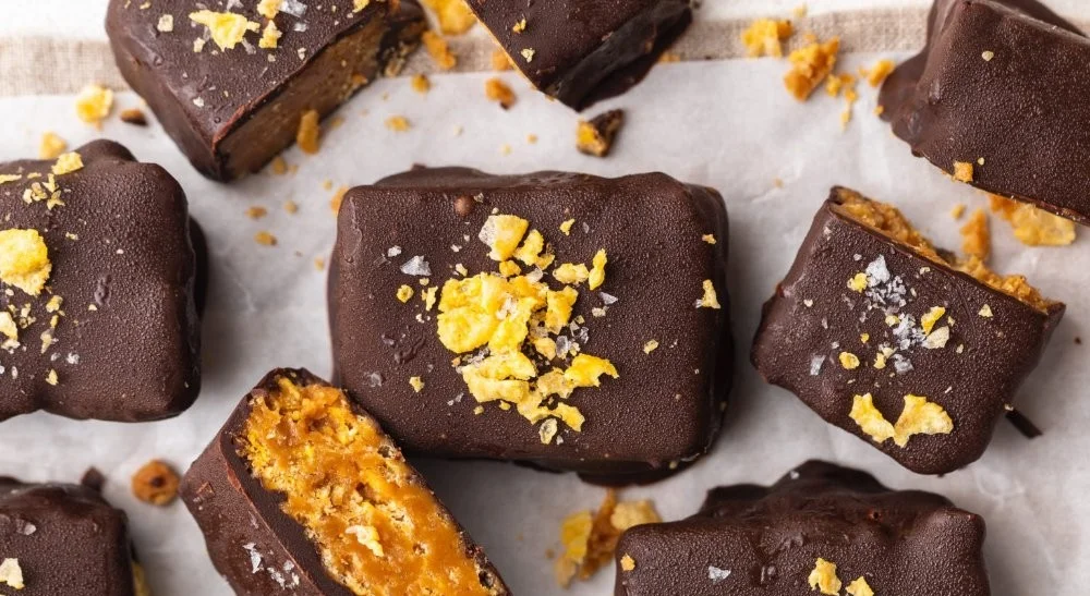 Healthy Homemade Butterfingers (5 ingredients!) 2 Healthy homemade Butterfingers made with five ingredients on a plate.