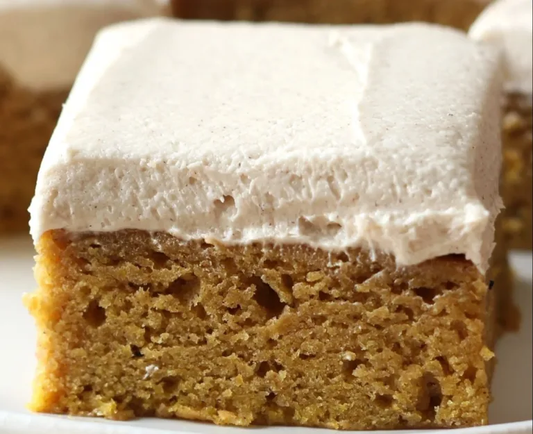 Delicious pumpkin bars with brown sugar frosting on a festive table