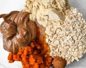Pumpkin Protein Balls 6 Homemade pumpkin protein balls on a wooden table with fall leaves