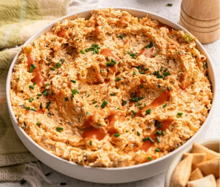 High-protein buffalo chicken salad topped with fresh greens and spicy dressing.