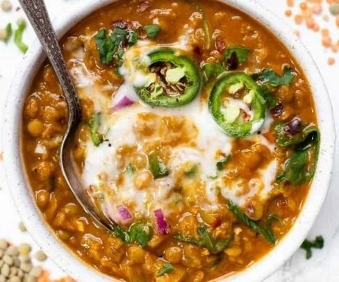 Home Loinzou 4 A bowl of flavorful Moroccan Lentil Soup garnished with fresh herbs.
